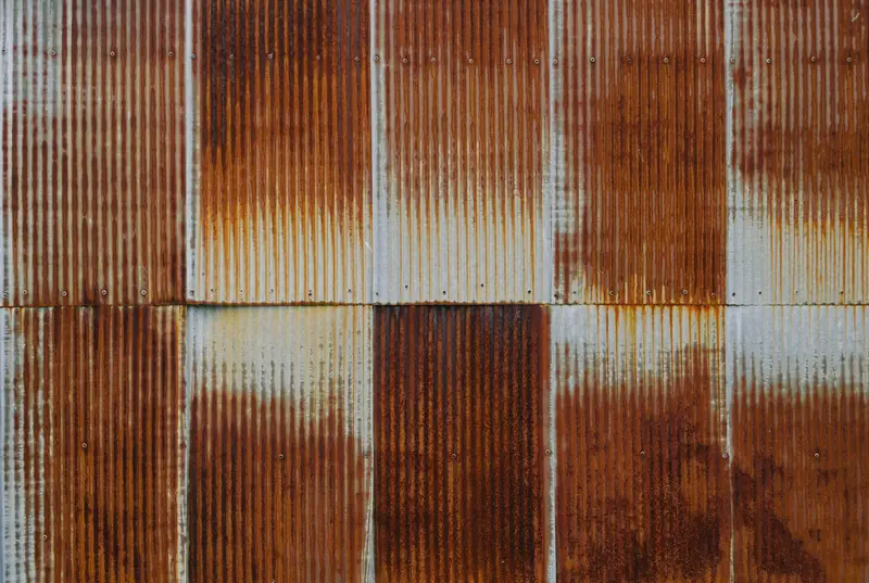Corrugated iron sheets with rust coming through